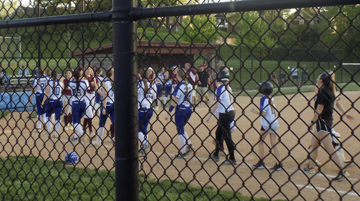 The Varsity team high fives Cooper players after the game ends. 